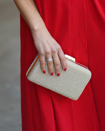 Mala de festa dourada com brilhantes